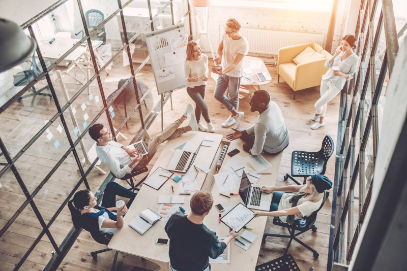 A photo of a meeting room with persons inside